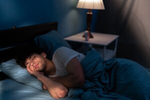 a man sleeping in his bed