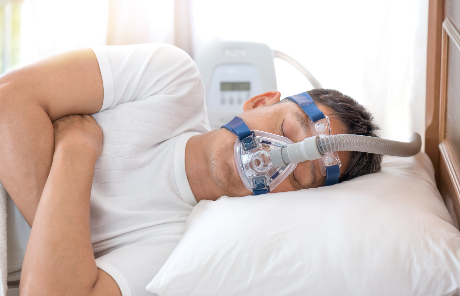 Man with sleep apnea mask